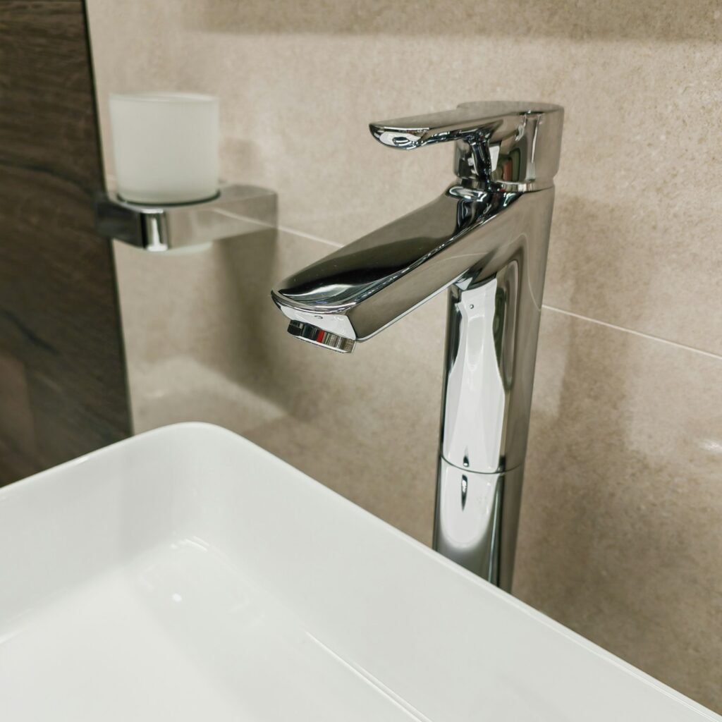 chrome plumbing faucet in the interior of a modern bathroom